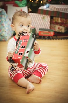 Cute Infant Baby Enjoying Christmas Morning Near The Tree.