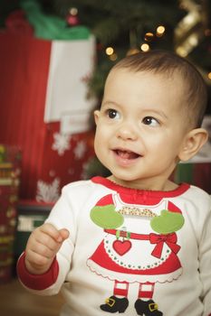 Cute Infant Baby Enjoying Christmas Morning Near The Tree.