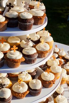 Wedding cupcakes of chocolate, vanilla, and carrotcake at a wedding reception.