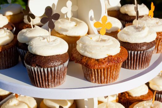 Wedding cupcakes of chocolate, vanilla, and carrotcake at a wedding reception.