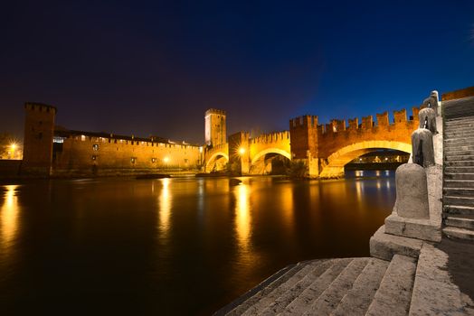 Castelvecchio - Scaliger bridge and Adige river at night in Verona - Italy