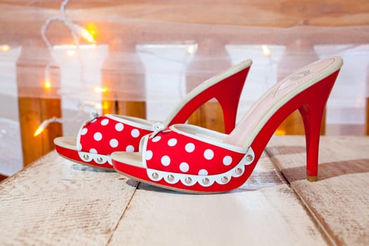 A bride's wedding shoes in red and white with polkadots and heels.