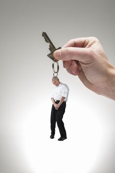 Creative conceptual shot of a studio man used as a key chain.