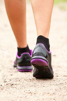 Close up of walking legs in shoes on the road