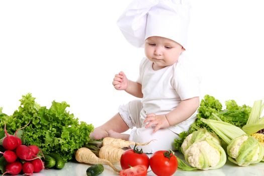 Baby cook with fresh vegetables isolated on a white