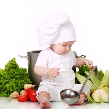 Baby cook with pan and vegetables isolated on a white