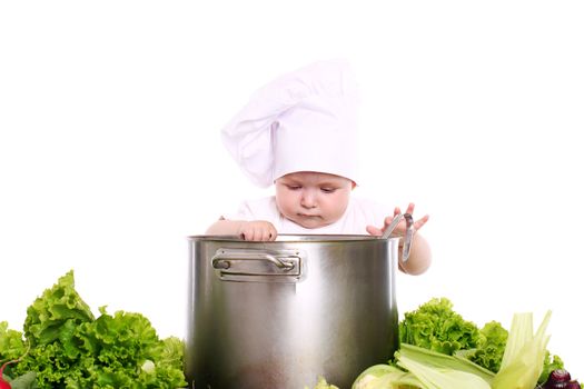 Baby cook with pan and vegetables isolated on a white