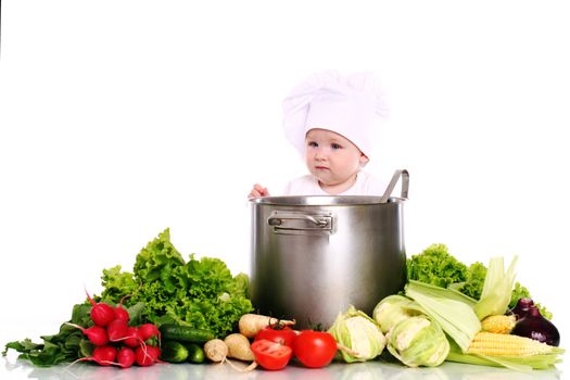 Baby cook with pan and vegetables isolated on a white