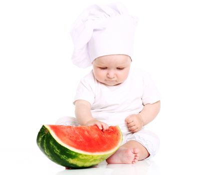 Happy baby cook eating watermelon isolated on a white