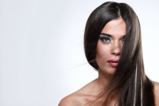 Close up of attractive woman with beautiful hair waved by wind