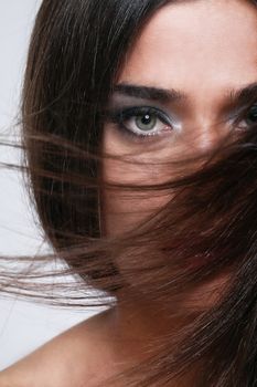 Close up of attractive woman with beautiful hair waved by wind