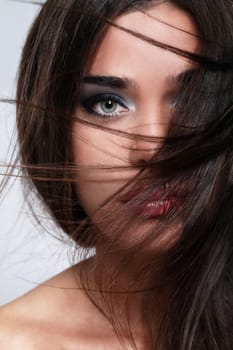 Close up of attractive woman with beautiful hair waved by wind