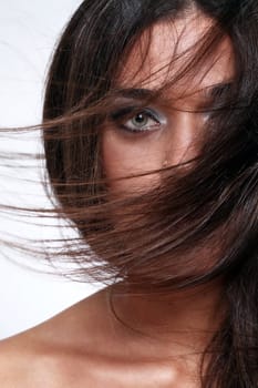 Close up of attractive woman with beautiful hair waved by wind