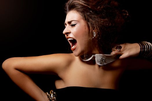 glamour elegant woman portrait with golden makeup on black shout scream