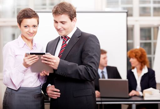 business team with tablet cellphone computer in office