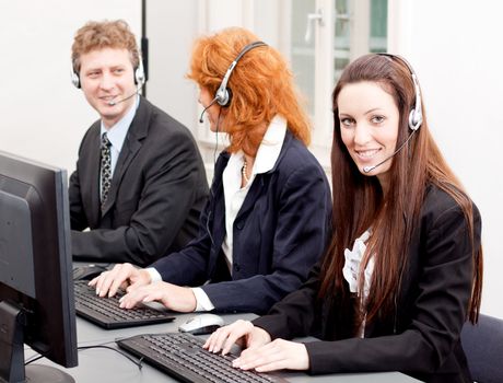 callcenter service team talking with headset workplace with computer