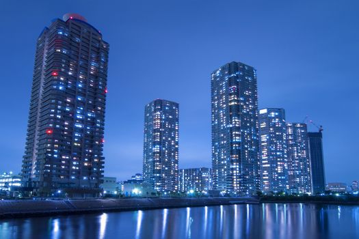 night skyscrapers cityscape in Tokyo metropolis over Sumida river waters