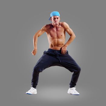 dancer of hip-hop on a gray background , motion