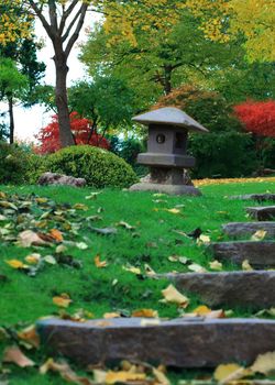 A lantern and stone stairs in a autumn japanese style garden 