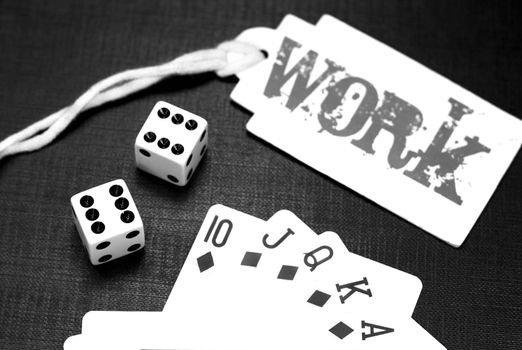 Two white dices and playing cards on a black background