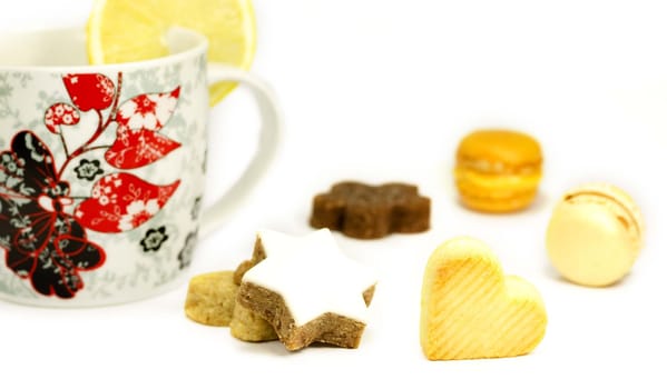 Cookies and mug with lemon on a white background