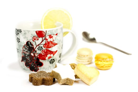Cookies and mug with lemon on a white background