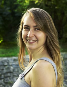 Smiling blond young woman in a nature background