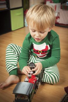 Cute Young Boy Enjoying Christmas Morning Near The Tree.