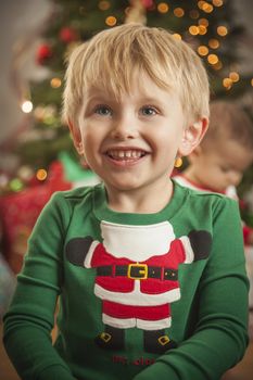 Cute Young Boy Enjoying Christmas Morning Near The Tree.