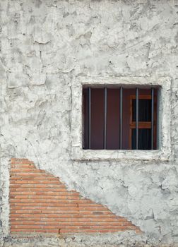 Prison window on the stone brick wall