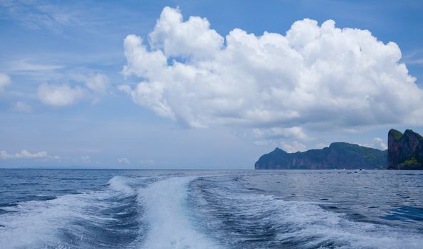 speedy boat prop wash, white wake on the blue ocean sea