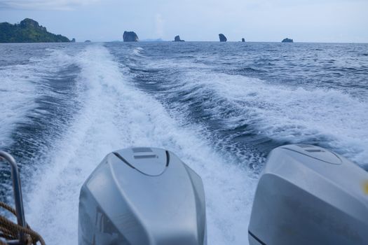 speedy boat prop wash, white wake on the blue ocean sea