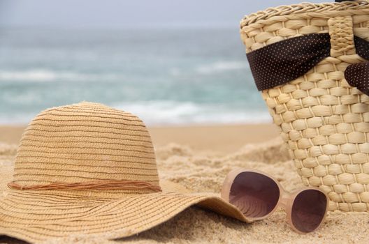 Seacoast, straw beach bag and sunglasses and hat	