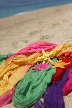 Funny starfishes on the beach and vivid fabrics