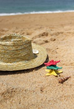 Funny starfishes on the beach and straw hat