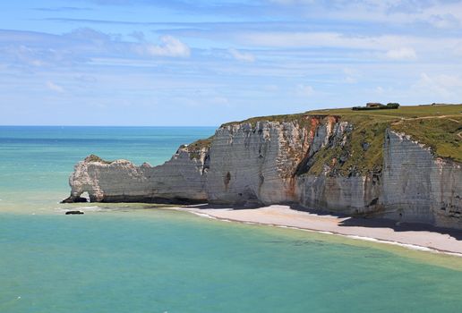La Falaise d'Amont in Etretat on the Upper Normandy coast in the North of France. The place is very famous for at least three reasons: 1.It features three famous natural arches, one of which you can see in this image: Port d'Amont. 2.It is a place which attracted the most famous impressionist painters as Monet,Courbet or Boudin and the whole coast is a hiking trail on the impressionists' path. 3.This is the highest promenade in the world which contains cultivated fields. 