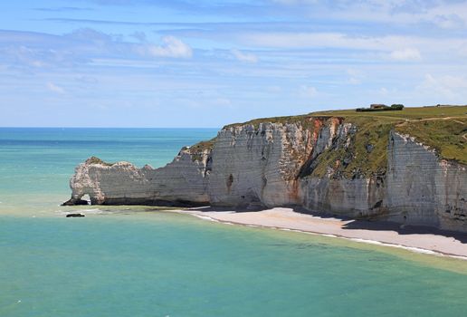 La Falaise d'Amont in Etretat on the Upper Normandy coast in the North of France. The place is very famous for at least three reasons: 1.It features three famous natural arches, one of which you can see in this image: Port d'Amont. 2.It is a place which attracted the most famous impressionist painters as Monet,Courbet or Boudin and the whole coast is a hiking trail on the impressionists' path. 3.This is the highest promenade in the world which contains cultivated fields. 