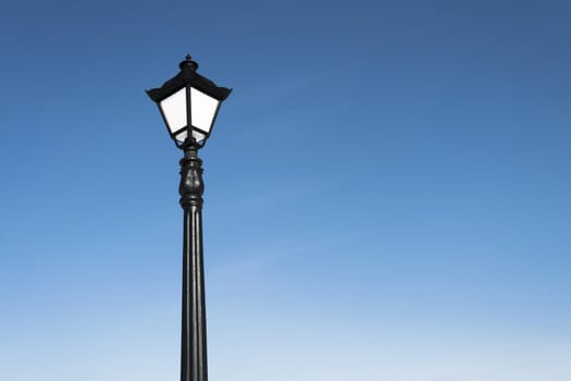 vintage street lamp over blue sky