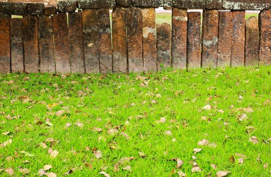 Stone block wall with green grass