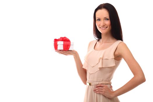 Beautiful young girl smiling and holding gift over a white background