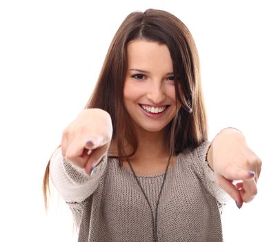 Smiling woman with long hair pointing at you over a white background