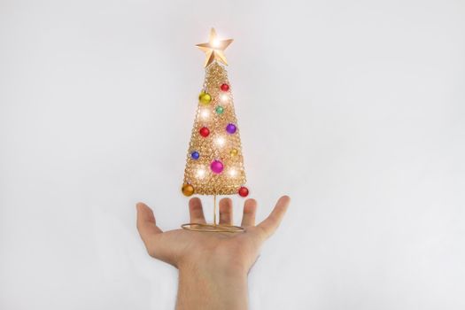 Christmas tree with toys and bright lights is on hand