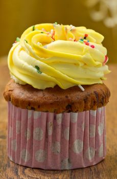Delicious vanilla cup cake with yellow icing