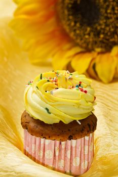 Delicious vanilla cup cake with yellow icing 