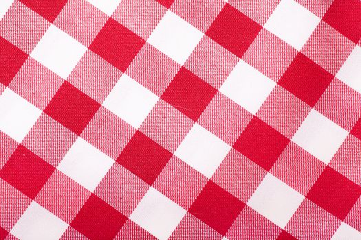 Closeup view of checked with red and white tablecloth