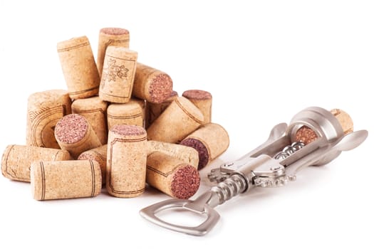Closeup top view of wine corks and corkscrew over white background