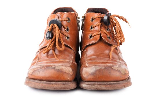 Child's old shoes with laces over white background