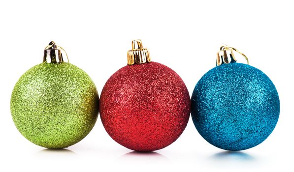 Red, green and blue christmas balls over white background