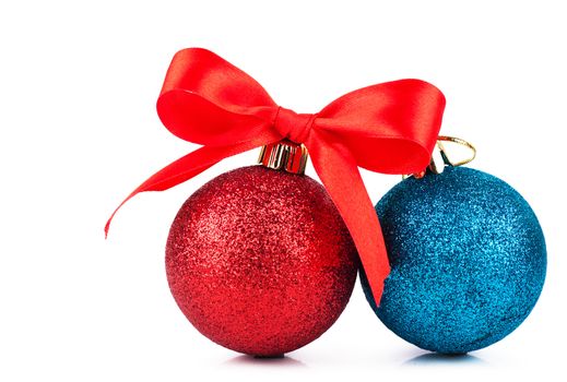 Red and blue christmas decorations with red bow over white background