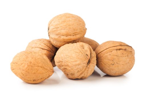 Closeup view of six walnuts over white background